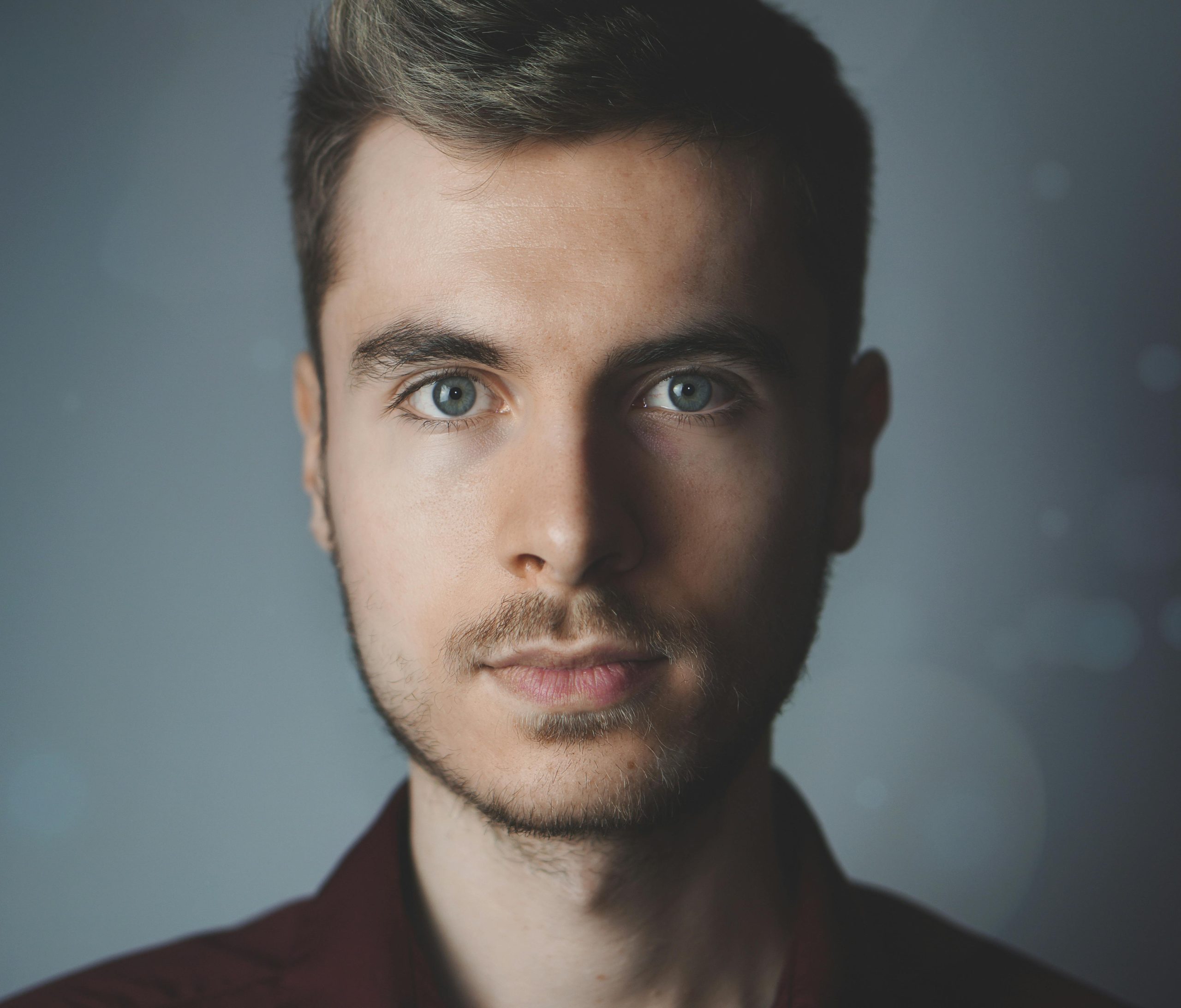 pexels-photo-614810-614810 - 快客Quick-洗鞋洗包到府收件 Close-up portrait of a young man with facial hair and a serious expression.