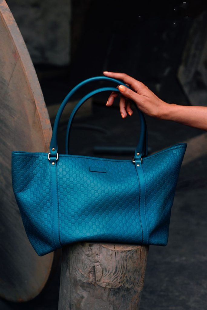 a hand holding a blue bag